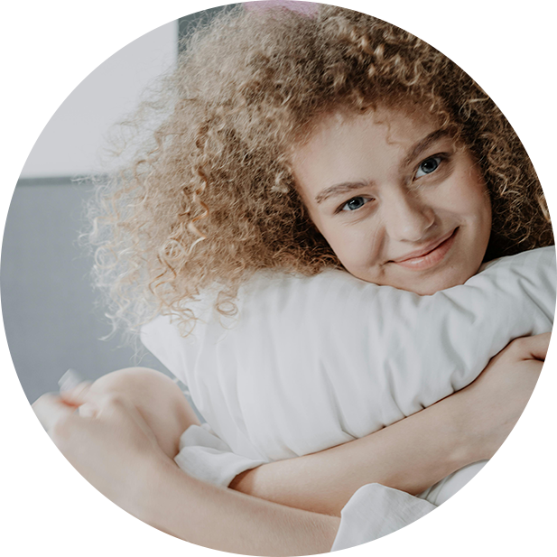 girl smiling holding pillow