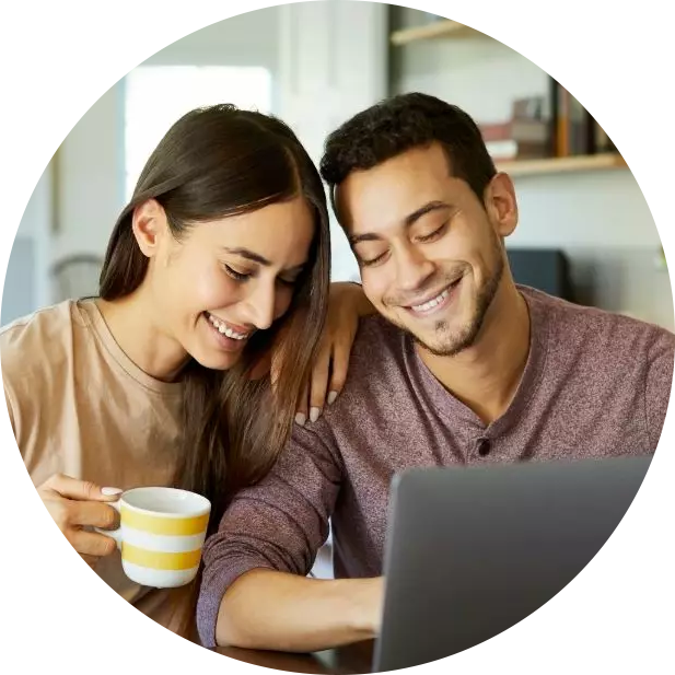 Man and woman looking at laptop smiling